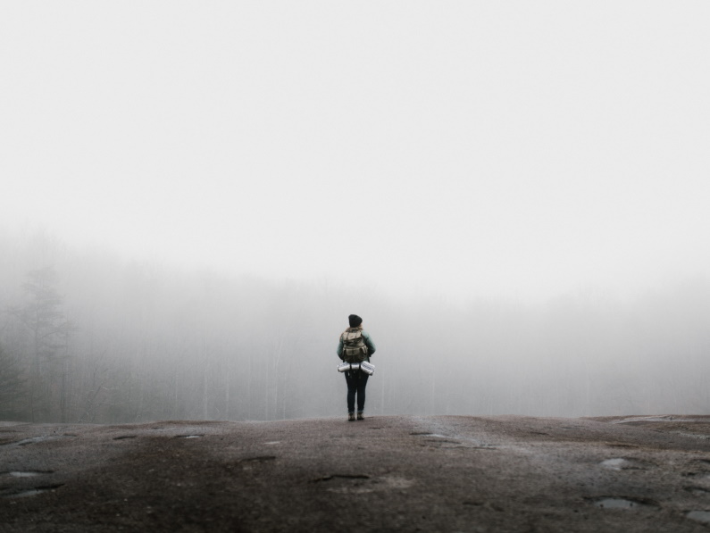 person standing in the fog, looking lost